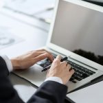 Business professional installing Tolling Vision on a laptop